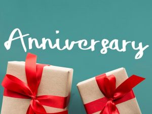 Celebrate Success with a Business Anniversary Announcement Press Release Two gift boxes wrapped in brown paper with red ribbons