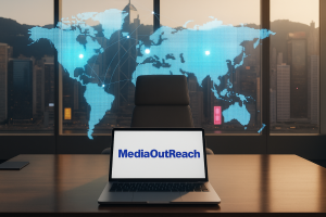 Laptop displaying MediaOutReach logo with world map overlay.