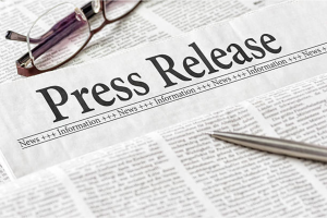 How to Embargo a Press Release: Tips & Examples Press release headline with pen and glasses on newspaper