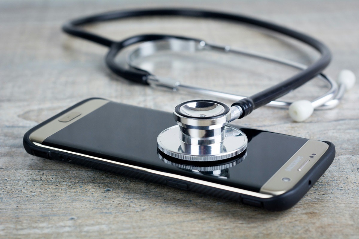 Mobile phone and stethoscope side by side, showing the intersection of healthcare and technology that drives telehealth press release coverage