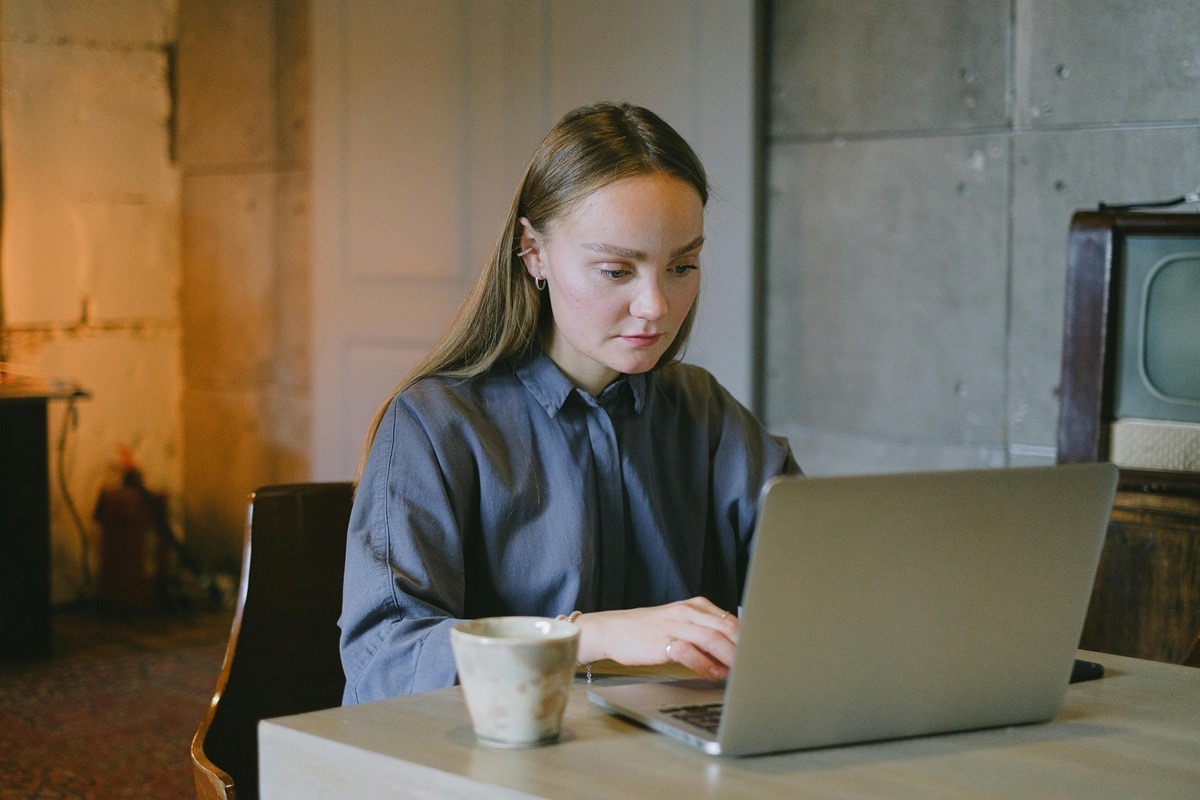 Writer drafting a press release on a laptop, focused on adding links and anchor text correctly