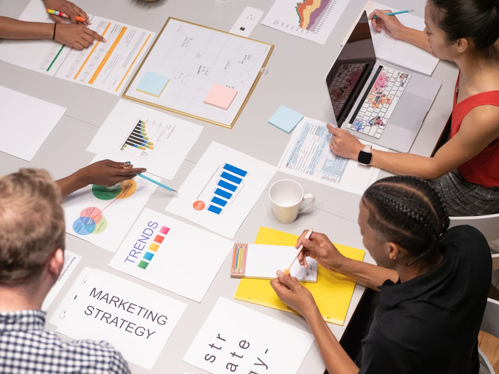 Marketing team reviewing strategy documents while planning a brand launch.