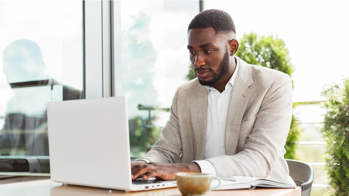 Marketing professional typing a press release on a laptop at a desk